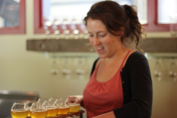 Abby pouring a flight in the Allagash Tasting Room, Photo by Phil Tracy